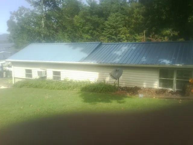 Blue metal roof running the length of a single story home in Hubertus